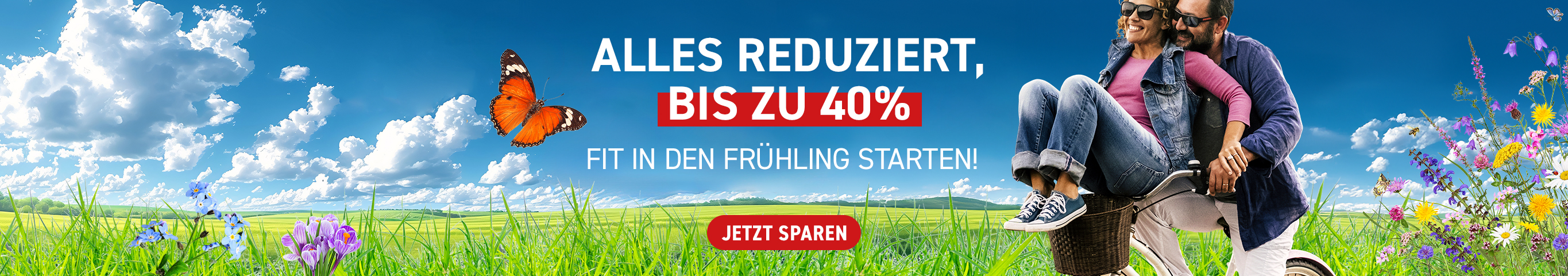 Ein Mann fährt seine Frau oder Freundin mit einem Fahrrad über eine blumenreiche Frühlingswiese. Beide lachen. Biltext: Alle Nahrungsergänzungsmittel im Feelgood Shop sind bis zu 40 % reduziert. Entdecke jetzt unsere Frühlingsangebote!